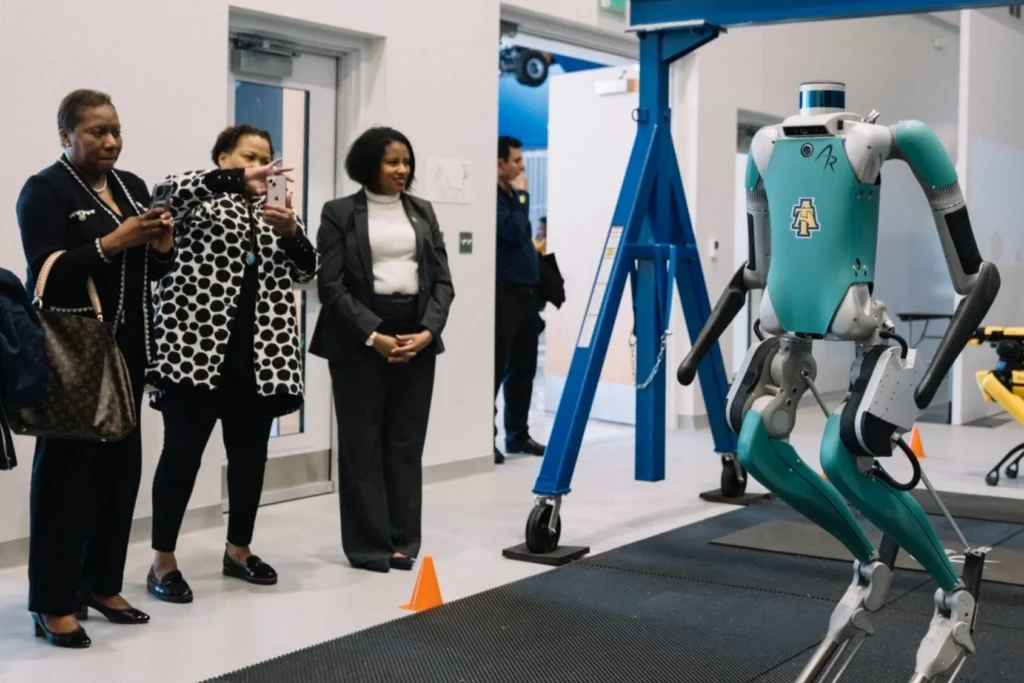 Visitors observing robotics demonstration at HBCU technology facility