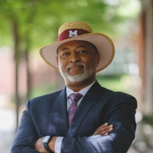 Professional portrait of Morehouse College representative wearing Morehouse hat and suit