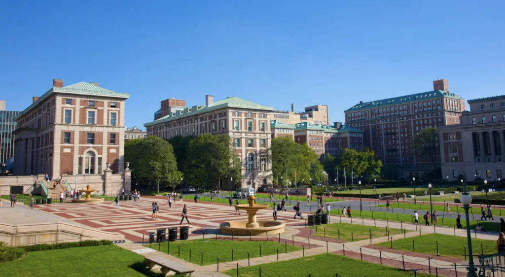 HBCU campus quad with historic brick buildings and students walking across plaza