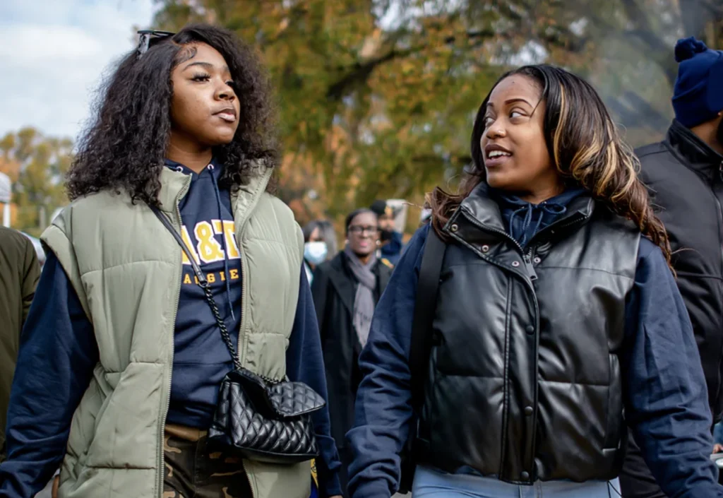 Two HBCU students in winter jackets walking on campus